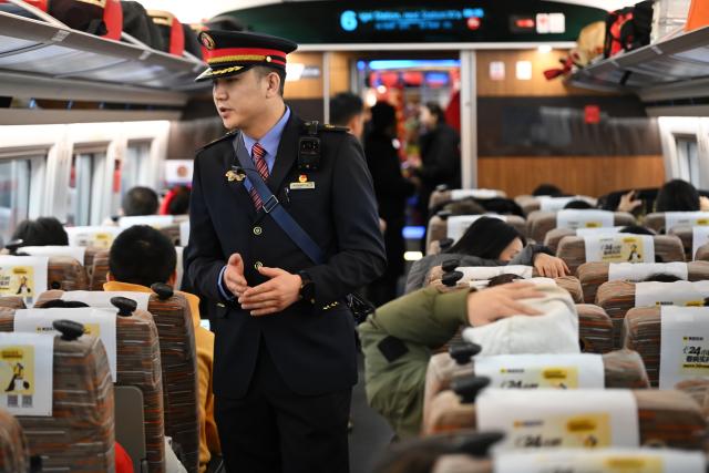 (260126) -- XI'AN, Jan. 26, 2026 (Xinhua) -- An attendant serves on the high-speed train G359 from Yan'an, northwest China's Shaanxi Province to the capital city of Beijing, Jan. 26, 2026. The high-speed train G359 departed from Yan'an on Monday morning, marking the first direct connection of high-speed rail from the sacred revolutionary site to the nation's capital city of Beijing.
   The fastest high-speed train ride from Yan'an to Beijing will take five hours and 42 minutes, a big improvement compared to the original train. (Xinhua/Li Yibo)