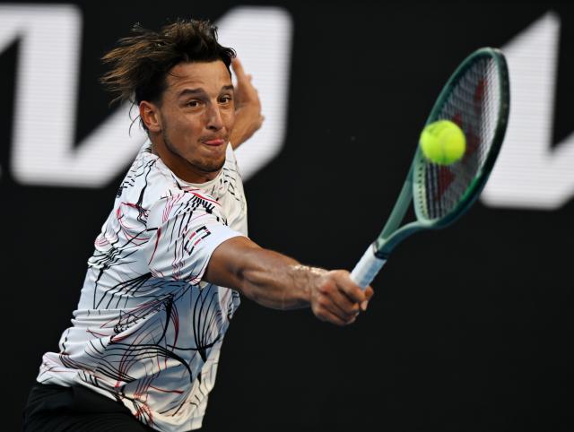 (260126) -- MELBOURNE, Jan. 26, 2026 (Xinhua) -- Luciano Darderi hits a return during the men's singles 4th round match between Luciano Darderi of Italy and Jannik Sinner of Italy at the Australian Open tennis tournament in Melbourne, Australia, Jan. 26, 2026. (Photo by Wang Shen/Xinhua)
