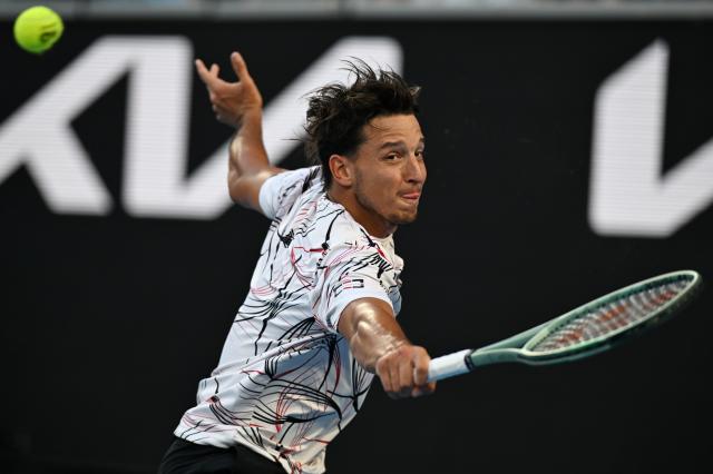 (260126) -- MELBOURNE, Jan. 26, 2026 (Xinhua) -- Luciano Darderi hits a return during the men's singles 4th round match between Luciano Darderi of Italy and Jannik Sinner of Italy at the Australian Open tennis tournament in Melbourne, Australia, Jan. 26, 2026. (Photo by Wang Shen/Xinhua)