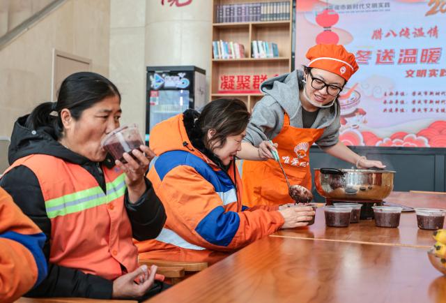 (260126) -- BEIJING, Jan. 26, 2026 (Xinhua) -- Sanitation workers taste Laba porridge at a community center in Rongcheng City, east China's Shandong Province, Jan. 26, 2026. The Laba Festival, which is celebrated each year on the eighth day of the twelfth lunar month with the custom of having Laba porridge, falls on Monday this year. (Photo by Li Xinjun/Xinhua)