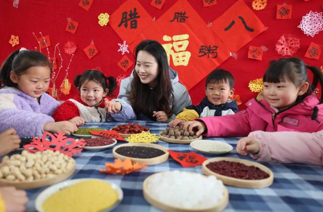 (260126) -- BEIJING, Jan. 26, 2026 (Xinhua) -- A teacher introduces ingredients for making Laba porridge at a kindergarten in Linyi City, east China's Shandong Province, Jan. 26, 2026. The Laba Festival, which is celebrated each year on the eighth day of the twelfth lunar month with the custom of having Laba porridge, falls on Monday this year. (Photo by Wang Yanbing/Xinhua)