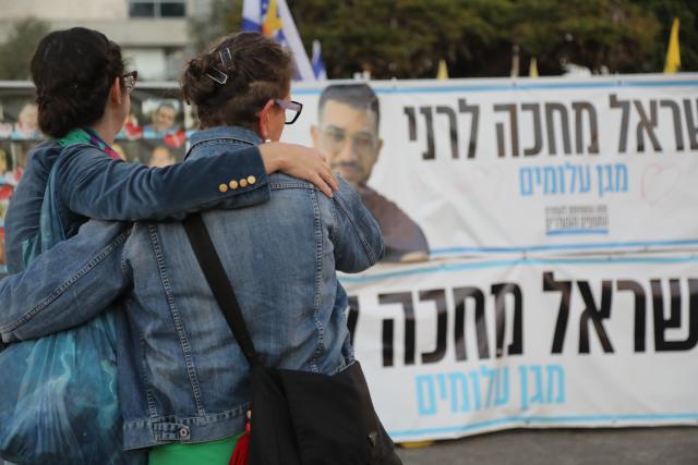 (260126) -- JERUSALEM, Jan. 26, 2026 (Xinhua) -- People watch posters of Ran Gvili, the last Israeli hostage whose remains have been found in the Gaza Strip, at a square in Tel Aviv, Israel, Jan. 26, 2026. The remains of Ran Gvili, the last hostage held in the Gaza Strip, had been identified and taken to Israel for burial, Israeli officials announced on Monday. (Gideon Markowicz/JINI via Xinhua)