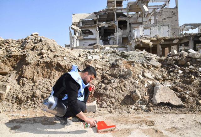 (260126) -- DAMASCUS, Jan. 26, 2026 (Xinhua) -- A member of Syria's Emergency and Disaster Management teams marks a cleared spot during a mine and unexploded ordnance survey in the Jobar neighborhood of Damascus, Syria, Jan. 26, 2026, as part of coordinated efforts to remove explosive hazards, support reconstruction, and facilitate the return of residents after years of conflict. (Photo by Ammar Safarjalani/Xinhua)