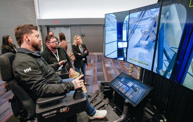 (260127) -- VANCOUVER, Jan. 27, 2026 (Xinhua) -- An attendee operates a mining training simulator during the Association for Mineral Exploration (AME) Roundup 2026 at the Vancouver Convention Centre in Vancouver, British Columbia, Canada, on Jan. 26, 2026. The AME Roundup 2026 kicked off here on Monday, featuring a four-day exhibition with exhibitors from around the world showcasing products, technologies and services related to mineral exploration and development. The event runs from Jan. 26 to Jan. 29. (Photo by Liang Sen/Xinhua)