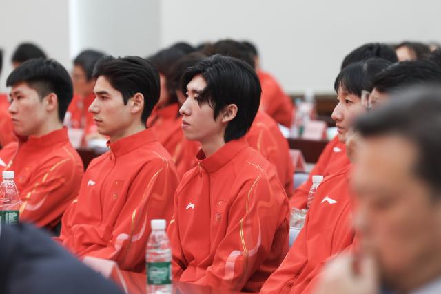 (260127) -- BEIJING, Jan. 27, 2026 (Xinhua) -- Short track speed skater Lin Xiaojun (3rd L) of the Chinese delegation for Milan-Cortina 2026 Olympic Winter Games is seen during the inaugural meeting of the Chinese delegation for Milan-Cortina 2026 Olympic Winter Games in Beijing, capital of China, on Jan. 27, 2026. (Xinhua/Na Yuqi)