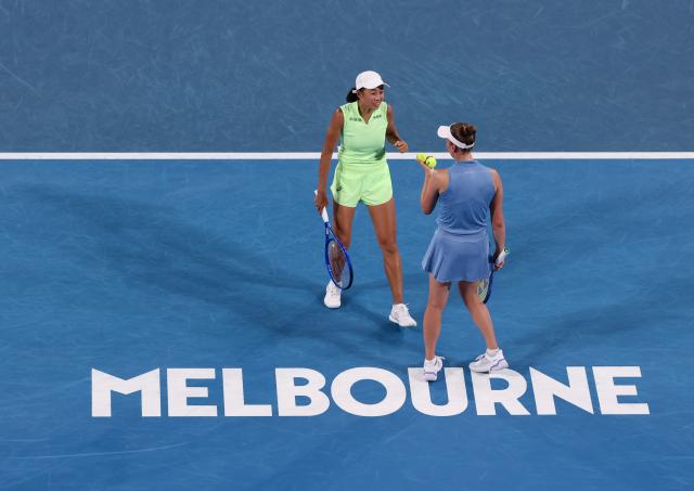 (260127) -- MELBOURNE, Jan. 27, 2026 (Xinhua) -- Zhang Shuai (L)/Elise Mertens react during the women's doubles 3rd round match between Zhang Shuai (China)/Elise Mertens (Belgium) and Hailey Baptiste/Peyton Stearns of the United States at the Australian Open tennis tournament in Melbourne, Australia, Jan. 27, 2026. (Xinhua/Ma Ping)