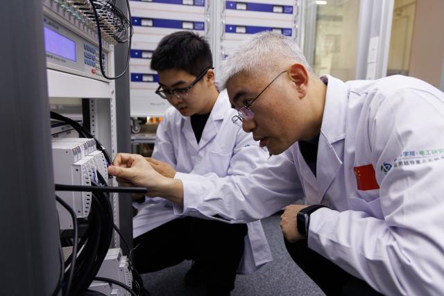 (260127) -- BEIJING, Jan. 27, 2026 (Xinhua) -- Researcher Liu Jianhua (R) and postdoctoral researcher Zhou Benzhe work at the ultra-low temperature high magnetic field quantum oscillation experimental station of the Institute of Physics of the Chinese Academy of Sciences in Beijing, capital of China, on Jan. 26, 2026. China has achieved a 35.6 tesla all-superconducting magnet in an experiment facility, setting a new record, the Chinese Academy of Sciences (CAS) said on Tuesday.
   The all-superconducting magnet, with a central magnetic field of 35.6 tesla and a usable aperture of 35 millimeters was conducted with the Synergetic Extreme Condition User Facility. It is a user magnet designed to support domestic and international research teams in conducting cutting-edge studies.
   The record-breaking magnetic field is about 12 to 24 times that of a medical magnetic resonance imaging (MRI) system, the strongest magnetic field people can access in daily life, and over 700,000 times that of Earth's magnetic field.
   As one of the core facilities in modern technology, they hold significant application value in major national sci-tech infrastructures, advanced scientific instruments, high-end medical equipment, energy and transportation. (Xinhua/Jin Liwang)