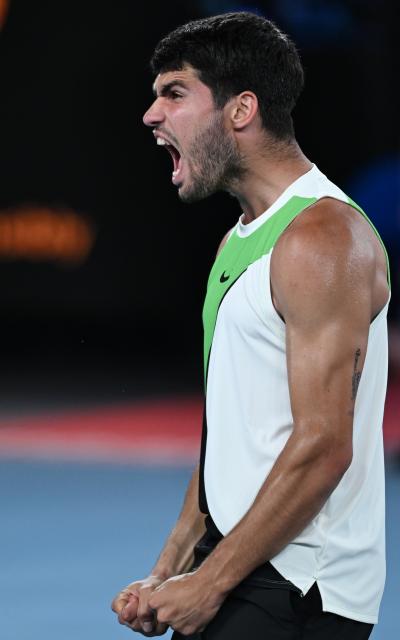 (260127) -- MELBOURNE, Jan. 27, 2026 (Xinhua) -- Carlos Alcaraz celebrates after winning the men's singles quarterfinal match between Carlos Alcaraz of Spain and Alex de Minaur of Australia at the Australian Open tennis tournament in Melbourne, Australia, Jan. 27, 2026. (Photo by Wang Shen/Xinhua)