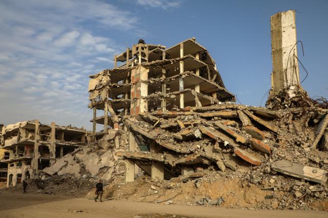 (260127) -- GAZA, Jan. 27, 2026 (Xinhua) -- Palestinians walk by destroyed buildings in the Zeitoun neighborhood, southeast of Gaza City, on Jan. 27, 2026. (Photo by Rizek Abdeljawad/Xinhua)