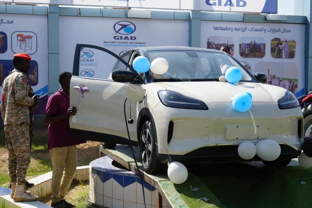 (260127) -- ATBARA, Jan. 27, 2026 (Xinhua) -- Visitors try out a Chinese electric car on display at the exhibition in Atbara, River Nile State, Sudan, Jan. 27, 2026. Atbara, a relatively stable city in northern Sudan's River Nile State, is hosting the "Made in River Nile" exhibition, which highlights Sudanese industry's resolve to aid economic recovery and revive national production, even amid the country's ongoing internal conflicts. (Photo by Fayez Elzaki/Xinhua)