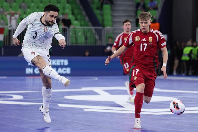 (260128) -- LJUBLJANA, Jan. 28, 2026 (Xinhua) -- Tomas Paco (L) of Portugal shoots during the UEFA Futsal EURO 2026 group match between Hungary and Portugal at Arena Stozice, Ljubljana, Slovenia, Jan. 27, 2026. (Photo by Zeljko Stevanic/Xinhua)