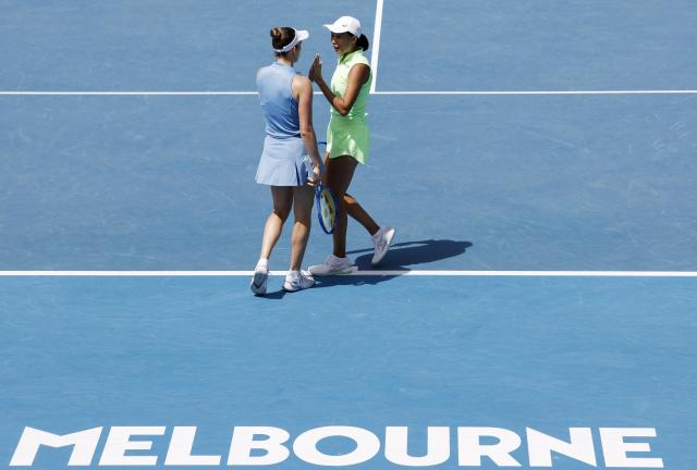 (260128) -- MELBOURNE, Jan. 28, 2026 (Xinhua) -- Zhang Shuai (R)/Elise Mertens react during the women's doubles quarterfinal match between Zhang Shuai (China)/Elise Mertens (Belgium) and Wu Fang-Hsien (Chinese Taipei)/Hozumi Eri (Japan) at the Australian Open tennis tournament in Melbourne, Australia, Jan. 28, 2026. (Xinhua/Ma Ping)