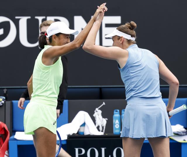 (260128) -- MELBOURNE, Jan. 28, 2026 (Xinhua) -- Zhang Shuai (L)/Elise Mertens celebrate winning during the women's doubles quarterfinal match between Zhang Shuai (China)/Elise Mertens (Belgium) and Wu Fang-Hsien (Chinese Taipei)/Hozumi Eri (Japan) at the Australian Open tennis tournament in Melbourne, Australia, Jan. 28, 2026. (Xinhua/Ma Ping)