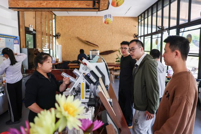 (260128) -- DING'AN, Jan. 28, 2026 (Xinhua) -- Customers place orders at a coffee shop in Fuwen Town of Ding'an County, south China's Hainan Province, Jan. 27, 2026.
  Amid China's rural revitalization drive, Ding'an County has been tapping into its own specialty and creativity to boost rural tourism. As a vivid example in developing village-based coffee businesses, the county is now home to 18 distinctive coffee shops, which blend coffee with local culture to create an authentic rustic atmosphere. (Xinhua/Zhang Liyun)