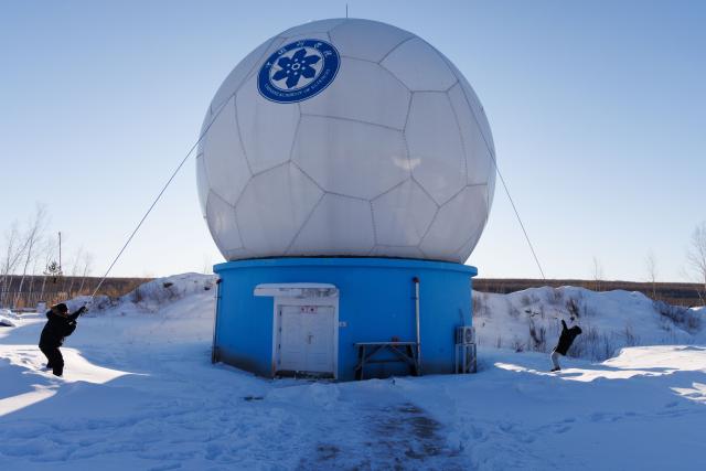 (260128) -- MOHE, Jan. 28, 2026 (Xinhua) -- Engineer Li Qiang (L) and Assistant Engineer Tian Dong clear snow on top of the antenna radome at the Mohe Station of the China Remote Sensing Satellite Ground Station in Mohe, northeast China's Heilongjiang Province, on Jan. 25, 2026.
  The Mohe Station of the China Remote Sensing Satellite Ground Station is China's northernmost satellite data receiving station. Normally the facility has only one staff member on duty, but as the Spring Festival approaches, four of its staff members have gathered in severe cold weather to conduct thorough winter inspections and maintenance.
  Developed by the Aerospace Information Research Institute under the Chinese Academy of Sciences, the Mohe Station commenced operations on Dec. 12, 2025.
  Located in Mohe, China's northernmost city in Heilongjiang Province, the station is designed to autonomously receive satellite data. It is now tasked with receiving data from 25 national land observation satellites, the institute said.
  The Mohe station boasts a maximum channel downlink data rate of 2 gigabits per second and can transmit the received data in real time. Leveraging its high-latitude geographical advantage, the station can extend the daily receiving time window for polar-orbiting satellites by over 20 percent. (Xinhua/Jin Liwang)