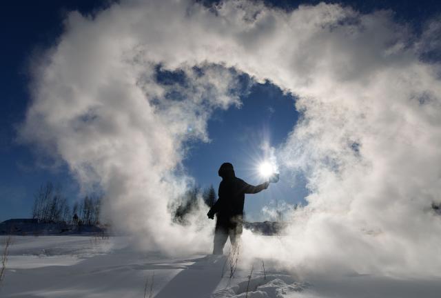 (260128) -- MOHE, Jan. 28, 2026 (Xinhua) -- Assistant Engineer Tian Dong plays a game in which splashed water turns into ice in extremely cold air at the Mohe Station of the China Remote Sensing Satellite Ground Station in Mohe, northeast China's Heilongjiang Province, on Jan. 25, 2026.
  The Mohe Station of the China Remote Sensing Satellite Ground Station is China's northernmost satellite data receiving station. Normally the facility has only one staff member on duty, but as the Spring Festival approaches, four of its staff members have gathered in severe cold weather to conduct thorough winter inspections and maintenance.
  Developed by the Aerospace Information Research Institute under the Chinese Academy of Sciences, the Mohe Station commenced operations on Dec. 12, 2025.
  Located in Mohe, China's northernmost city in Heilongjiang Province, the station is designed to autonomously receive satellite data. It is now tasked with receiving data from 25 national land observation satellites, the institute said.
  The Mohe station boasts a maximum channel downlink data rate of 2 gigabits per second and can transmit the received data in real time. Leveraging its high-latitude geographical advantage, the station can extend the daily receiving time window for polar-orbiting satellites by over 20 percent. (Xinhua/Jin Liwang)