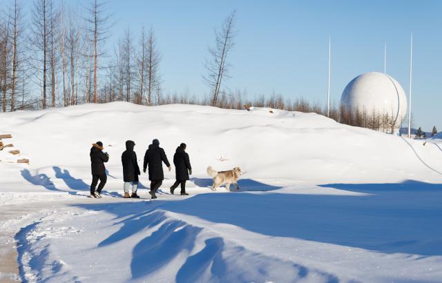 (260128) -- MOHE, Jan. 28, 2026 (Xinhua) -- Staff members return to the office building after maintaining the satellite data receiving system at the Mohe Station of the China Remote Sensing Satellite Ground Station in Mohe, northeast China's Heilongjiang Province, on Jan. 25, 2026.
  The Mohe Station of the China Remote Sensing Satellite Ground Station is China's northernmost satellite data receiving station. Normally the facility has only one staff member on duty, but as the Spring Festival approaches, four of its staff members have gathered in severe cold weather to conduct thorough winter inspections and maintenance.
  Developed by the Aerospace Information Research Institute under the Chinese Academy of Sciences, the Mohe Station commenced operations on Dec. 12, 2025.
  Located in Mohe, China's northernmost city in Heilongjiang Province, the station is designed to autonomously receive satellite data. It is now tasked with receiving data from 25 national land observation satellites, the institute said.
  The Mohe station boasts a maximum channel downlink data rate of 2 gigabits per second and can transmit the received data in real time. Leveraging its high-latitude geographical advantage, the station can extend the daily receiving time window for polar-orbiting satellites by over 20 percent. (Xinhua/Jin Liwang)