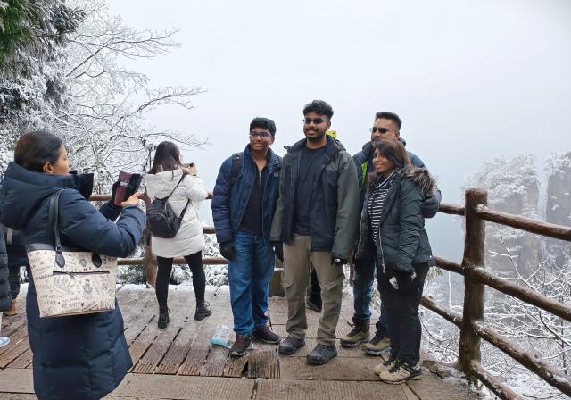 (260128) -- BEIJING, Jan. 28, 2026 (Xinhua) -- Malaysian tourists pose for group photos at Zhangjiajie National Forest Park in central China's Hunan Province, Jan. 2, 2026.
  Fueled by China's expanding visa-free policies, inbound travel surged in 2025, with visa-free entries jumping 49.5 percent year-on-year to nearly 30.1 million, official data showed.
  The National Immigration Administration said on Wednesday that international visitors made over 82 million crossings in total, marking a 26.4 percent year-on-year increase.
  Currently, China offers visa-free entry to citizens of 76 countries. Plus, travelers from 55 countries can take advantage of a 240-hour visa-free transit policy at 65 different entry points. 
  Beyond short-term visits, this openness is fostering a vibrant community of international residents. More scholars, students, and professionals are choosing to live and work in China, deepening people-to-people bonds. China, with much to be explored and a lot more to offer, continues to captivate hearts and minds worldwide. (Photo by Wu Yongbing/Xinhua)