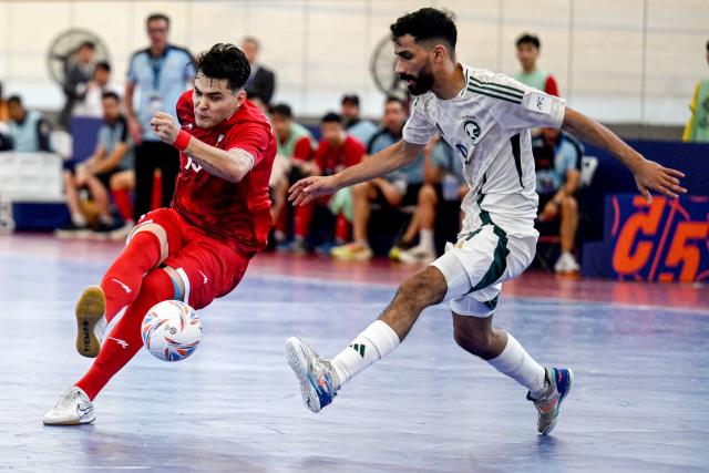 (260128) -- JAKARTA, Jan. 28, 2026 (Xinhua) -- Seyed Hossein Mousavi (L) of Afghanistan shoots during the group D match  between Afghanistan and Saudi Arabia at the AFC Futsal Asian Cup 2026 in Jakarta, Indonesia, Jan. 28, 2026. (Xinhua/Agung Kuncahya B.)