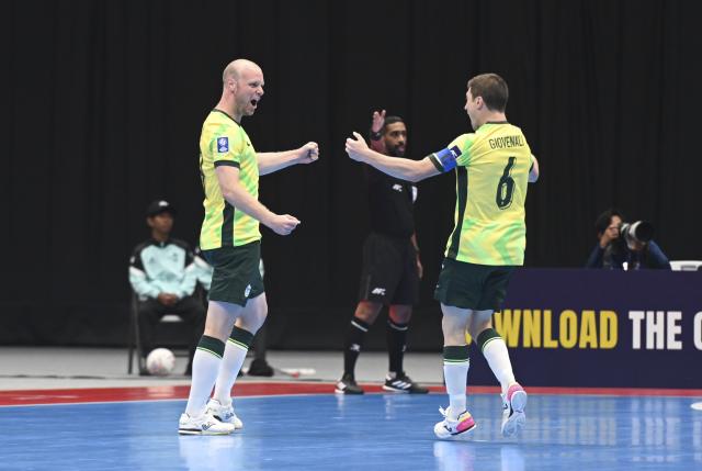 (260128) -- JAKARTA, Jan. 28, 2026 (Xinhua) -- Grant Lynch (L) of Australia celebrates after scoring during the group C match between Japan and Australia at the AFC Futsal Asian Cup 2026 in Jakarta, Indonesia, Jan. 28, 2026. (Xinhua/Zulkarnain)