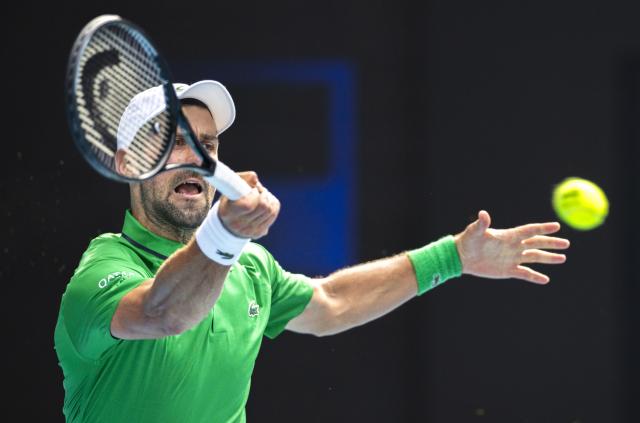 (260128) -- MELBOURNE, Jan. 28, 2026 (Xinhua) -- Novak Djokovic of Serbia hits a return during the men's singles quarterfinal match between Novak Djokovic of Serbia and Lorenzo Musetti of Italy at the Australian Open tennis tournament in Melbourne, Australia, Jan. 28, 2026. (Photo by Hu Jingchen/Xinhua)