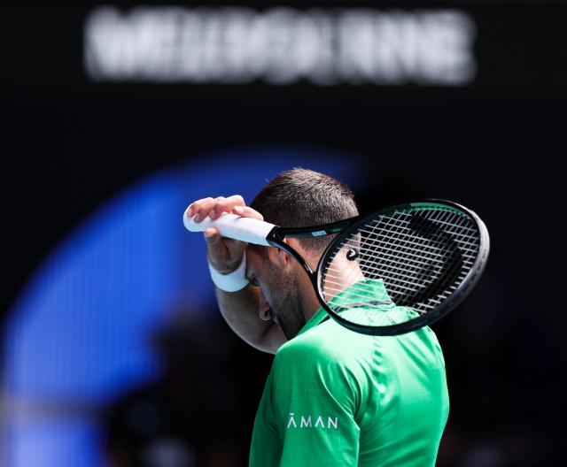 (260128) -- MELBOURNE, Jan. 28, 2026 (Xinhua) -- Novak Djokovic of Serbia reacts during the men's singles quarterfinal match between Novak Djokovic of Serbia and Lorenzo Musetti of Italy at the Australian Open tennis tournament in Melbourne, Australia, Jan. 28, 2026. (Xinhua/Ma Ping)
