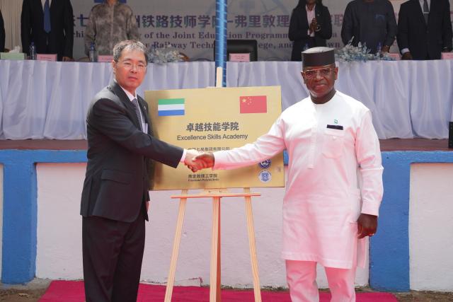 (260128) -- FREETOWN, Jan. 28, 2026 (Xinhua) -- Chinese Ambassador to Sierra Leone Zhao Yong (L) and Sierra Leonean President Julius Maada Bio attend the inauguration ceremony of a jointly-built vocational academy in Freetown, Sierra Leone, on Jan. 27, 2026. China Railway Seventh Group Co., Ltd. (CRSG), in collaboration with Zhengzhou Railway Technician College and Freetown Polytechnic, officially launched the Excellence Skills Academy on Tuesday in Sierra Leone's capital, Freetown.
   TO GO WITH "Chinese enterprise, college launch vocational academy in Sierra Leone" (CRSG/Handout via Xinhua)