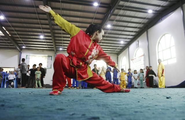 (260129) -- SANAA, Jan. 29, 2026 (Xinhua) -- A female competitor of the junior category performs during a Wushu and Kung Fu competition in Sanaa, Yemen, on Jan. 28, 2026. (Photo by Mohammed Mohammed/Xinhua)