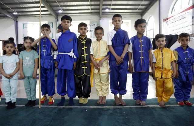 (260129) -- SANAA, Jan. 29, 2026 (Xinhua) -- Yemeni junior competitors take photos during a Wushu and Kung Fu competition in Sanaa, Yemen, on Jan. 28, 2026. (Photo by Mohammed Mohammed/Xinhua)