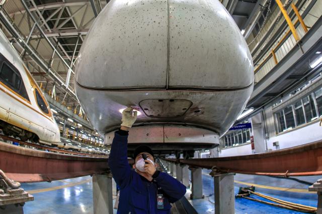 (260129) -- BEIJING, Jan. 29, 2026 (Xinhua) -- A staff member conducts maintenance work at a high-speed train base in Nanjing, east China's Jiangsu Province, Jan. 27, 2026. Railway departments nationwide are actively conducting train maintenance to ensure safe operations during the upcoming 2026 Spring Festival travel rush. (Photo by Xin Yi/Xinhua)