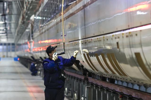 (260129) -- BEIJING, Jan. 29, 2026 (Xinhua) -- A staff member conducts maintenance work at a high-speed train base in Nanjing, east China's Jiangsu Province, Jan. 27, 2026. Railway departments nationwide are actively conducting train maintenance to ensure safe operations during the upcoming 2026 Spring Festival travel rush. (Photo by Xin Yi/Xinhua)