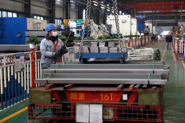 (260129) -- BEIJING, Jan. 29, 2026 (Xinhua) -- A worker cranes materials for making export containers at a company in an economic and technological development zone in Lianyungang, east China's Jiangsu Province, Jan. 29, 2026. Enterprises across the country are going full steam ahead in production at the end of January, striving for a strong start in the first month of a new year. (Photo by Wang Chun/Xinhua)
