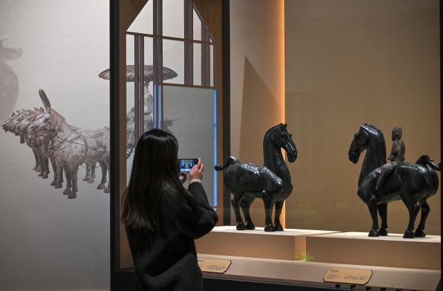 (260129) -- BEIJING, Jan. 29, 2026 (Xinhua) -- A visitor takes photos at an exhibition themed on Chinese zodiac Year of the Horse at the National Museum of China in Beijing, capital of China, Jan. 29, 2026. The exhibition, displaying over 120 pieces (sets) of cultural relics, will open here on Jan. 30. (Xinhua/Jin Liangkuai)