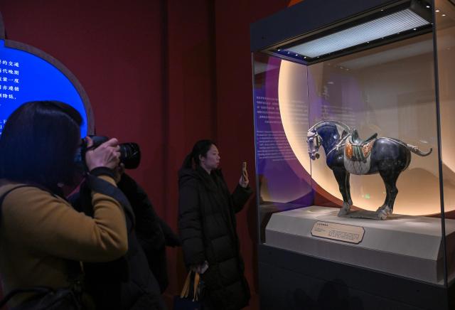 (260129) -- BEIJING, Jan. 29, 2026 (Xinhua) -- People view an exhibit at an exhibition themed on Chinese zodiac Year of the Horse at the National Museum of China in Beijing, capital of China, Jan. 29, 2026. The exhibition, displaying over 120 pieces (sets) of cultural relics, will open here on Jan. 30. (Xinhua/Jin Liangkuai)