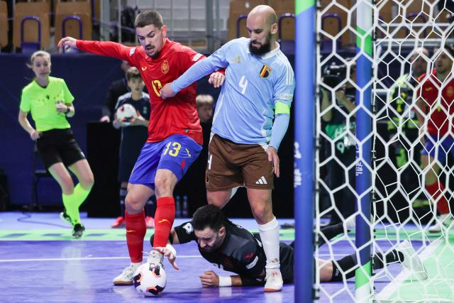 (260130) -- LJUBLJANA, Jan. 30, 2026 (Xinhua) -- Omar Rahou (R) of Belgium vies with Mellado (L) and Didac Plana (bottom) of Spain during the UEFA Futsal EURO 2026 group match between Spain and Belgium at Arena Stozice, Ljubljana, Slovenia, Jan. 29, 2026. (Photo by Zeljko Stevanic/Xinhua)