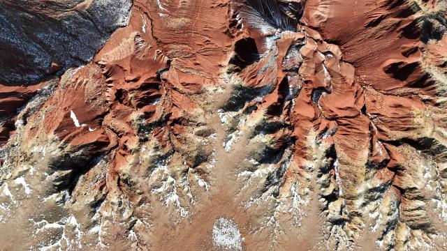 (260130) -- ULANQAB, Jan. 30, 2026 (Xinhua) -- An aerial drone photo taken on Jan. 29, 2026 shows a scene of the Hongya Tableland in Siziwang Banner, north China's Inner Mongolia Autonomous Region. Located in the northern part of Siziwang Banner in Ulanqab, the Hongya Tableland is a key component of the Siziwang National Geopark in north China's Inner Mongolia Autonomous Region. Featuring towering red hills and deep gullies, the landscape forms a majestic painting with lingering snow. (Xinhua/Bei He)