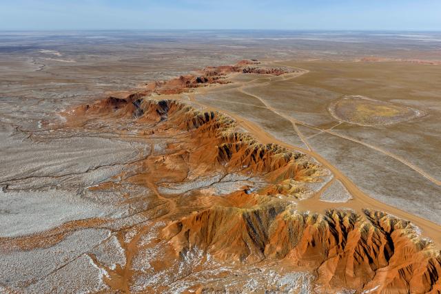 (260130) -- ULANQAB, Jan. 30, 2026 (Xinhua) -- An aerial drone photo taken on Jan. 29, 2026 shows a scene of the Hongya Tableland in Siziwang Banner, north China's Inner Mongolia Autonomous Region. Located in the northern part of Siziwang Banner in Ulanqab, the Hongya Tableland is a key component of the Siziwang National Geopark in north China's Inner Mongolia Autonomous Region. Featuring towering red hills and deep gullies, the landscape forms a majestic painting with lingering snow. (Xinhua/Ma Jinrui)