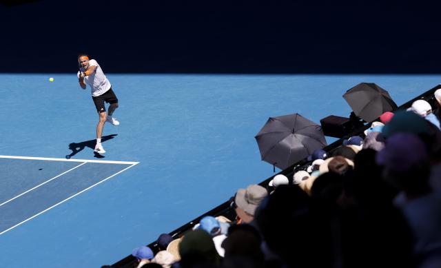 (260130) -- MELBOURNE, Jan. 30, 2026 (Xinhua) -- Alexander Zverev hits a return during the men's singles semifinal match between Carlos Alcaraz of Spain and Alexander Zverev of Germany at the Australian Open tennis tournament in Melbourne, Australia, Jan. 30, 2026. (Xinhua/Ma Ping)