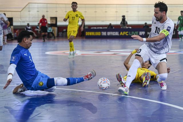 (260130) -- JAKARTA, Jan. 30, 2026 (Xinhua) -- Akbar Kazemi (R) of Afghanistan vies with Muhammad Syawal Sabaruddin (L) of Malaysia during the match in Group D between Malaysia and Afghanistan at the AFC Futsal Asian Cup 2026 in Jakarta, Indonesia, Jan. 30, 2026. (Xinhua/Agung Kuncahya B.)