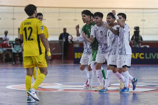 (260130) -- JAKARTA, Jan. 30, 2026 (Xinhua) -- Players of Afghanistan celebrate after scoring during the match in Group D between Malaysia and Afghanistan at the AFC Futsal Asian Cup 2026 in Jakarta, Indonesia, Jan. 30, 2026. (Xinhua/Agung Kuncahya B.)
