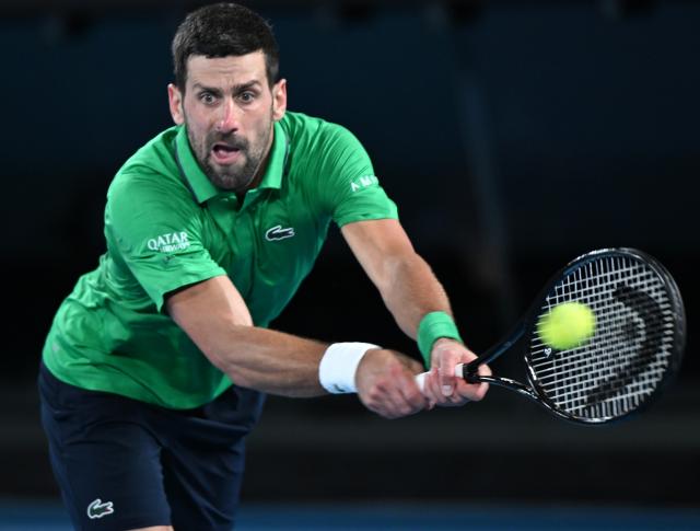 (260130) -- MELBOURNE, Jan. 30, 2026 (Xinhua) -- Novak Djokovic hits a return during the men's singles semifinal match between Novak Djokovic of Serbia and Jannik Sinner of Italy at the Australian Open tennis tournament in Melbourne, Australia, Jan. 31, 2026. (Photo by Wang Shen/Xinhua)