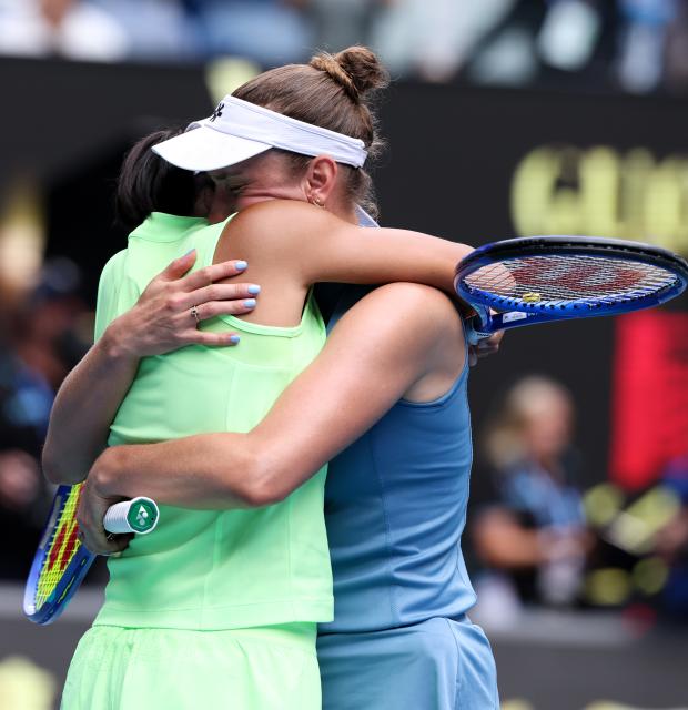 (260131) -- MELBOURNE, Jan. 31, 2026 (Xinhua) -- Zhang Shuai (L) hugs Elise Mertens after winning the women's doubles final match between Zhang Shuai (China)/Elise Mertens (Belgium) and Anna Danilina (Kazakhstan)/Aleksandra Krunic (Serbia) at the Australian Open tennis tournament in Melbourne, Australia, Jan. 31, 2026. (Xinhua/Ma Ping)