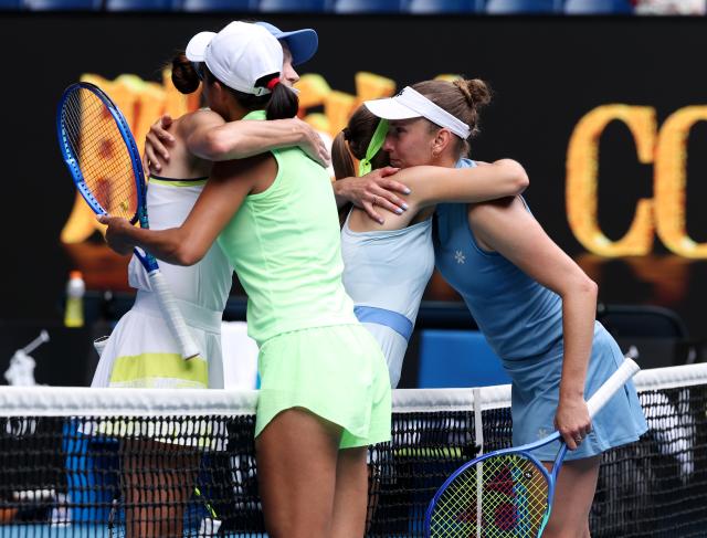 (260131) -- MELBOURNE, Jan. 31, 2026 (Xinhua) -- Zhang Shuai (front R)/Elise Mertens (back R) hug Anna Danilina (front L)/Aleksandra Krunic after the women's doubles final match between Zhang Shuai (China)/Elise Mertens (Belgium) and Anna Danilina (Kazakhstan)/Aleksandra Krunic (Serbia) at the Australian Open tennis tournament in Melbourne, Australia, Jan. 31, 2026. (Xinhua/Ma Ping)
