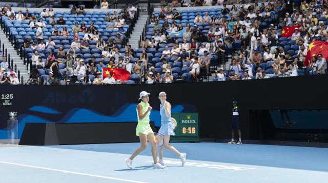 (260131) -- MELBOURNE, Jan. 31, 2026 (Xinhua) -- Zhang Shuai (L)/Elise Mertens celebrate scoring during the women's doubles final match between Zhang Shuai (China)/Elise Mertens (Belgium) and Anna Danilina (Kazakhstan)/Aleksandra Krunic (Serbia) at the Australian Open tennis tournament in Melbourne, Australia, Jan. 31, 2026. (Photo by Hu Jingchen/Xinhua)