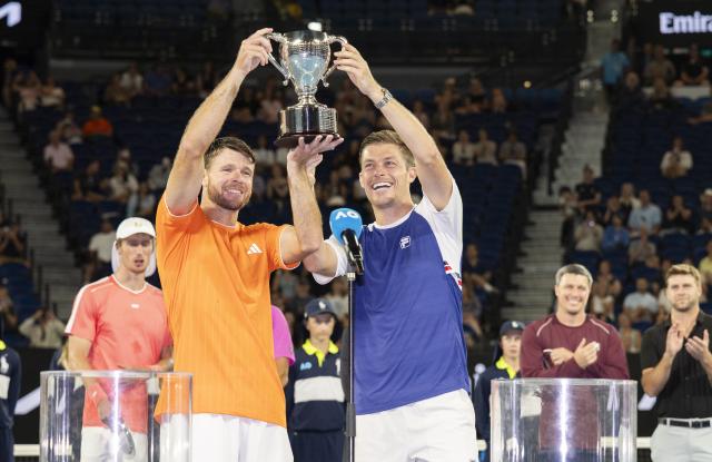 (260131) -- MELBOURNE, Jan. 31, 2026 (Xinhua) -- Christian Harrison (L)/Neal Skupski hold the trophy during the awarding ceremony for the men's doubles final match between Jason Kubler/Marc Polmans (Australia) and Christian Harrison (the United States)/Neal Skupski (Britain) at the Australian Open tennis tournament in Melbourne, Australia, Jan. 31, 2026. (Photo by Hu Jingchen/Xinhua)
