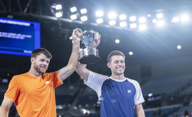 (260131) -- MELBOURNE, Jan. 31, 2026 (Xinhua) -- Christian Harrison (L)/Neal Skupski hold the trophy during the awarding ceremony for the men's doubles final match between Jason Kubler/Marc Polmans (Australia) and Christian Harrison (the United States)/Neal Skupski (Britain) at the Australian Open tennis tournament in Melbourne, Australia, Jan. 31, 2026. (Photo by Hu Jingchen/Xinhua)