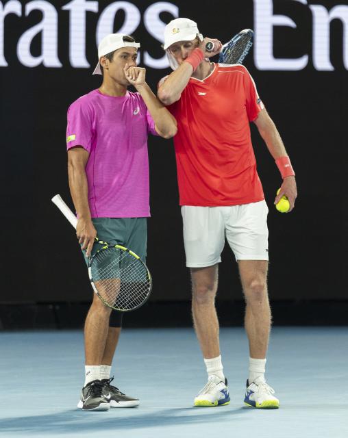 (260131) -- MELBOURNE, Jan. 31, 2026 (Xinhua) -- Jason Kubler (L)/Marc Polmans discuss during the men's doubles final match between Jason Kubler/Marc Polmans (Australia) and Christian Harrison (the United States)/Neal Skupski (Britain) at the Australian Open tennis tournament in Melbourne, Australia, Jan. 31, 2026. (Photo by Hu Jingchen/Xinhua)