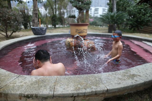 (260131) -- SHIQIAN, Jan. 31, 2026 (Xinhua) -- Tourists enjoy leisure time at a hot spring resort in Shiqian County, southwest China's Guizhou Province, Jan. 27, 2026. By integrating its rich hot spring resources with tourism, healthcare, and intangible cultural heritage, Shiqian county has boosted local tourism and created employment opportunities, making it an important driving force of rural revitalization. (Xinhua/Liu Xu)