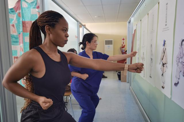 (260131) -- WINDHOEK, Jan. 31, 2026 (Xinhua) -- Ding Jumei (R), a traditional medicine nursing specialist of the 16th batch of the China Medical Team in Namibia, guides a patient to practice Baduanjin, a traditional Chinese exercise, at the Chinese acupuncture clinic at Katutura Intermediate Hospital in Windhoek, Namibia, on Jan. 28, 2026. The Chinese Acupuncture Clinic is combining acupuncture with traditional Chinese exercise methods to help improve the health of local residents.
   TO GO WITH "Feature: Needles and Qigong: Chinese medical team brings holistic healing to Namibia" (Photo by Ndalimpinga Iita/Xinhua)