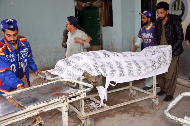 (260131) -- QUETTA, Jan. 31, 2026 (Xinhua) -- Rescuers transfer a victim's body in Quetta, southwest Pakistan's Balochistan province, on Jan. 31, 2026. At least 58 terrorists, 15 troops, policemen and civilians were killed during follow-up operations launched in response to coordinated attacks in Pakistan's southwestern Balochistan province, security sources said on Saturday. (Photo by Asad/Xinhua)